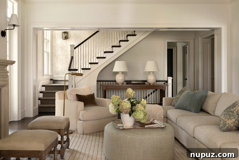 Timeless Home Tour: Warm Neutrals and Layered Interior Style 7 Neutral living room with stools in front of the fireplace and a round ottoman