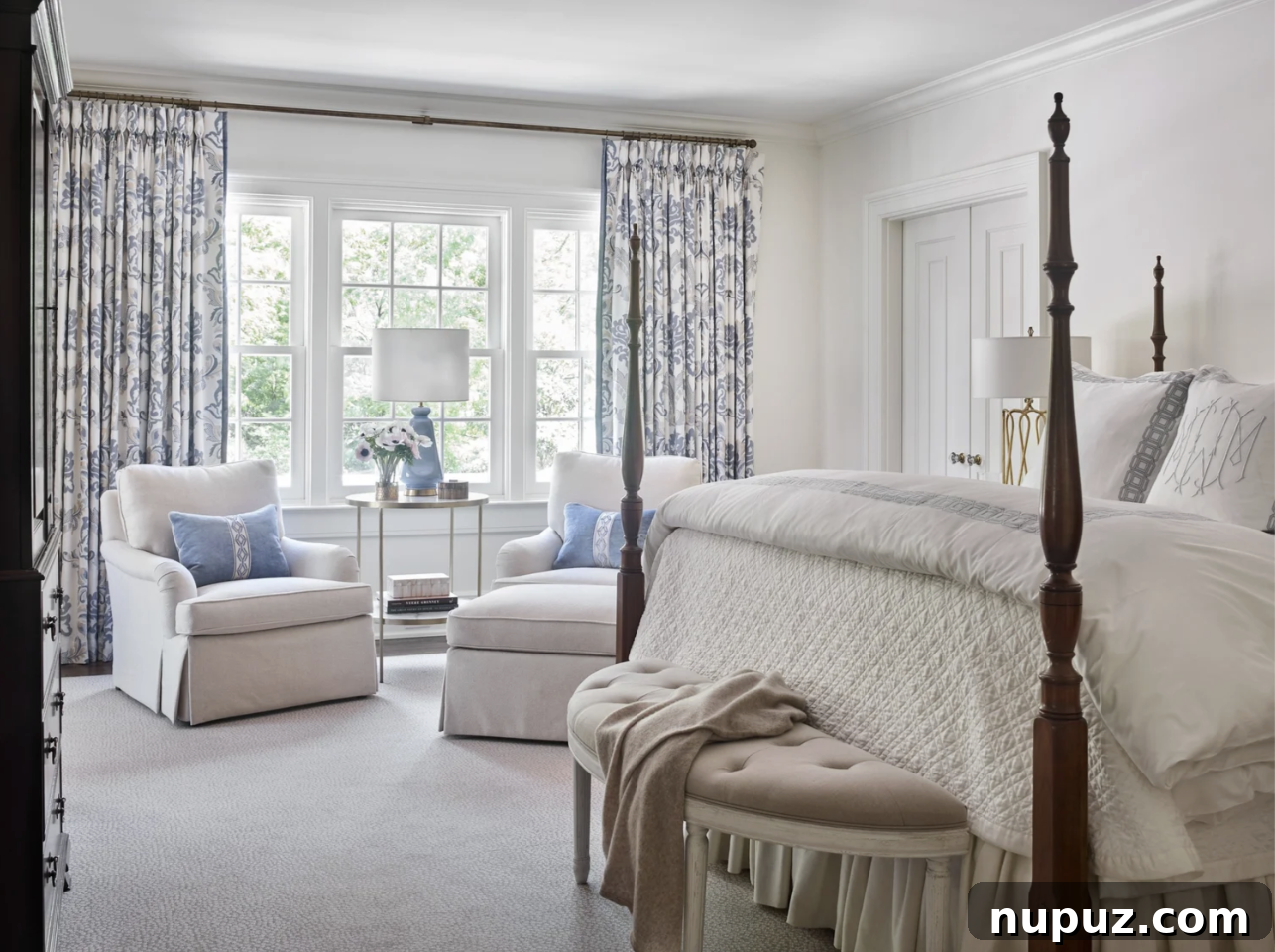 Primary bedroom with four-poster bed and layered linens