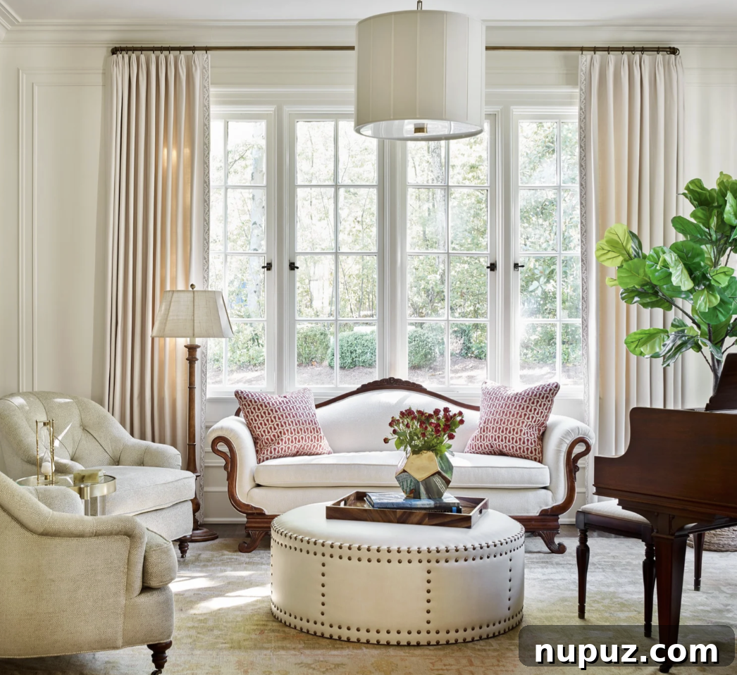 Formal living room with white sofa, ottoman and grand piano