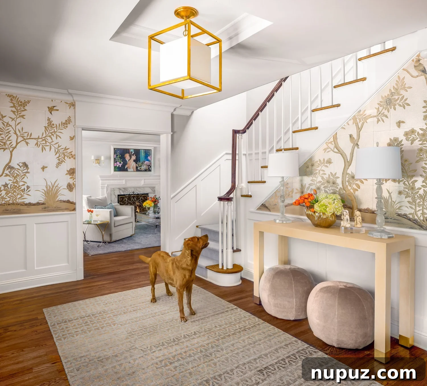 this beautiful foyer with neutral wallpaper with a console table is creating a Timeless home design