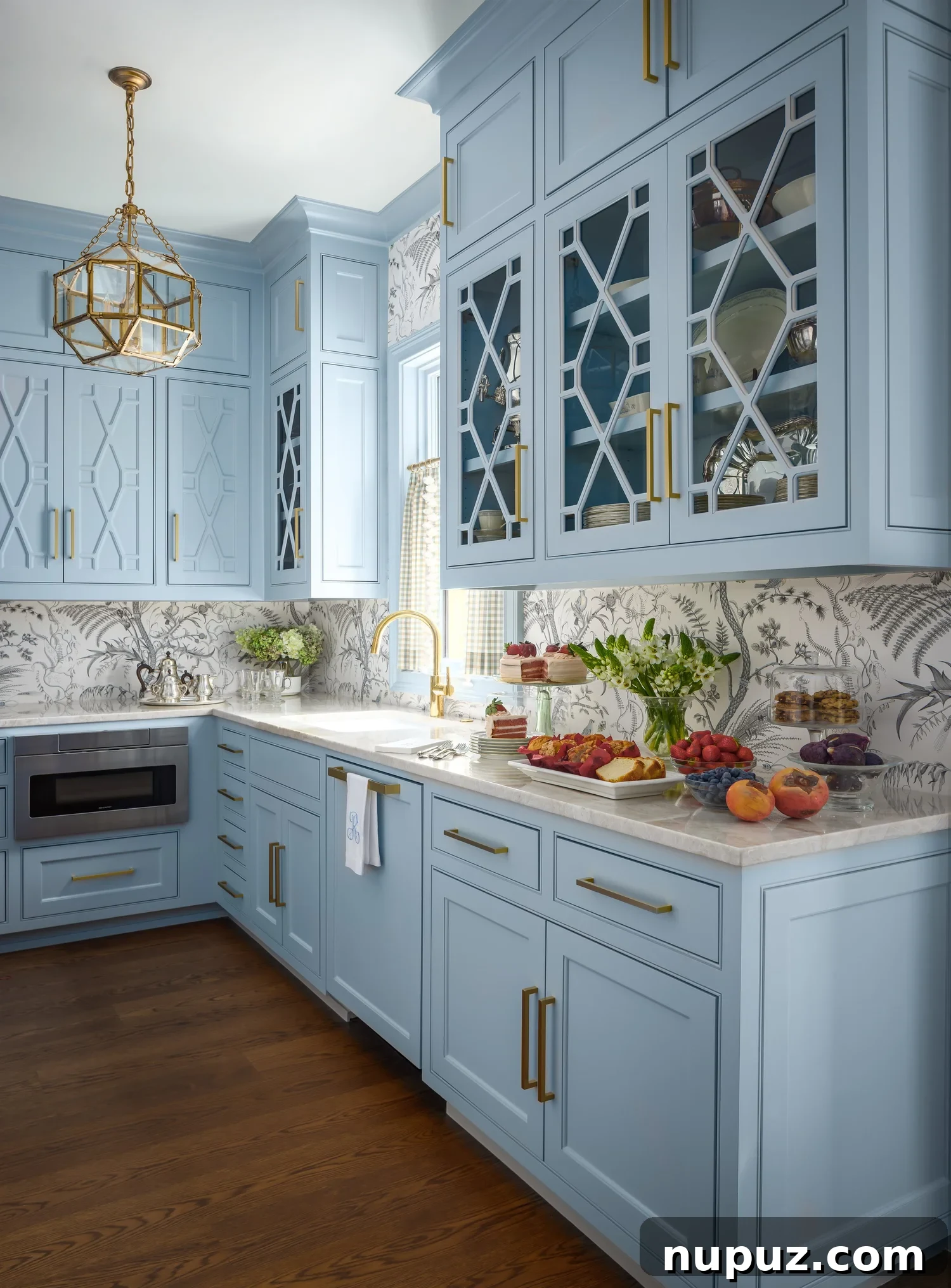 Beautiful blue kitchen with glass front shelves and a timeless home design