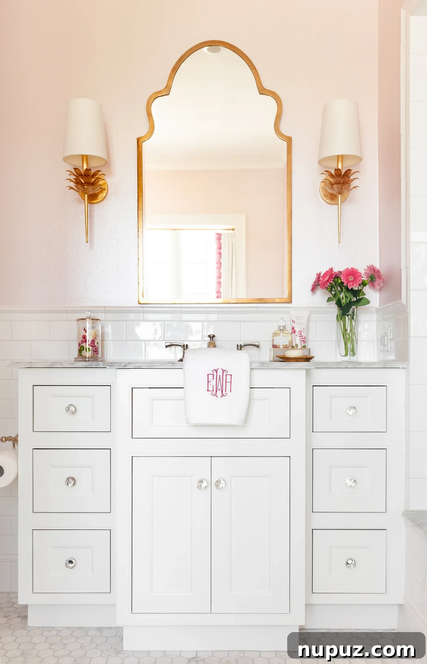 Beautiful bathroom with white cabinets and monogrammed towels