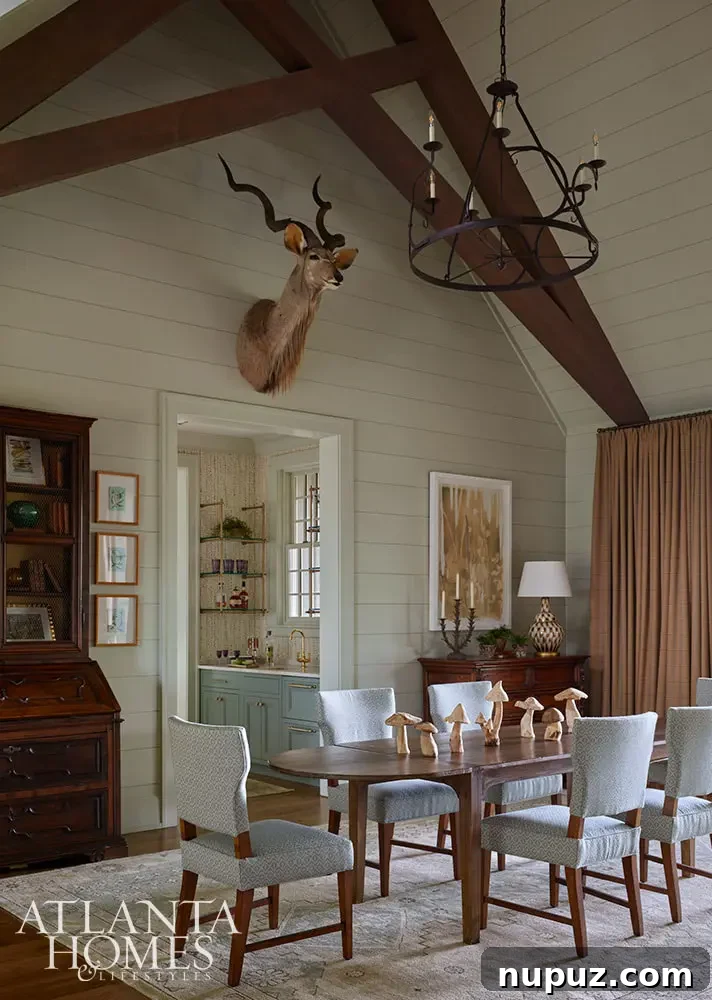Beautiful dining room with oval dining table and deer taxidermy