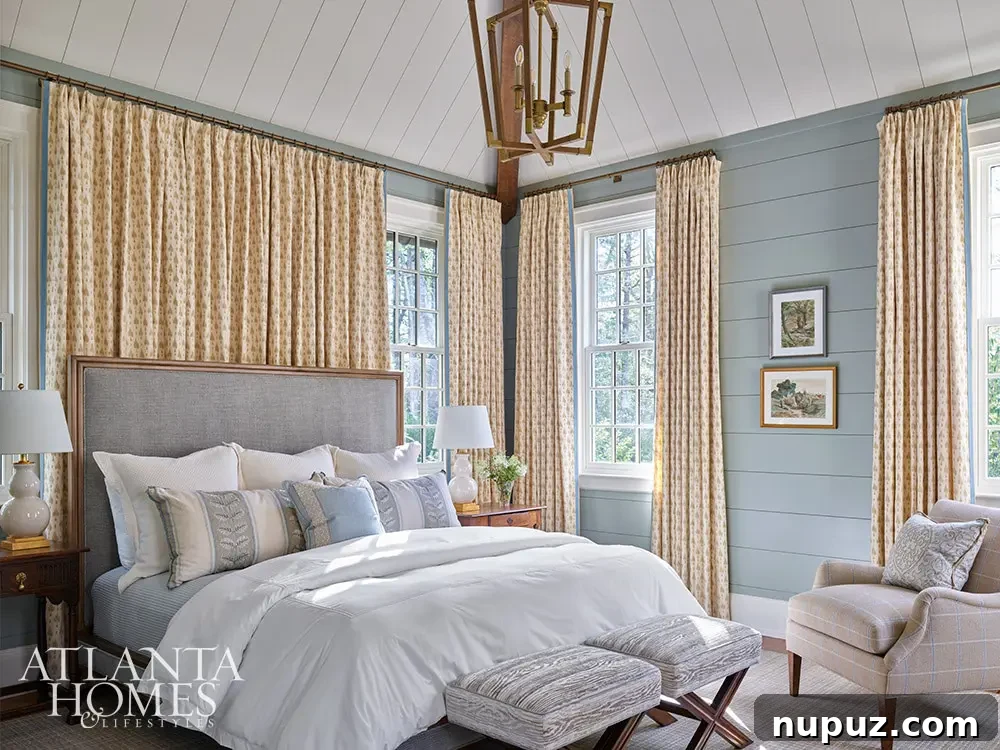 Primary bedroom with blue shiplap walls and blue and white bedding