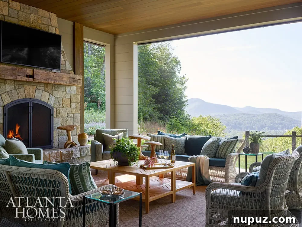 Covered porch with stone fireplace and soft seating