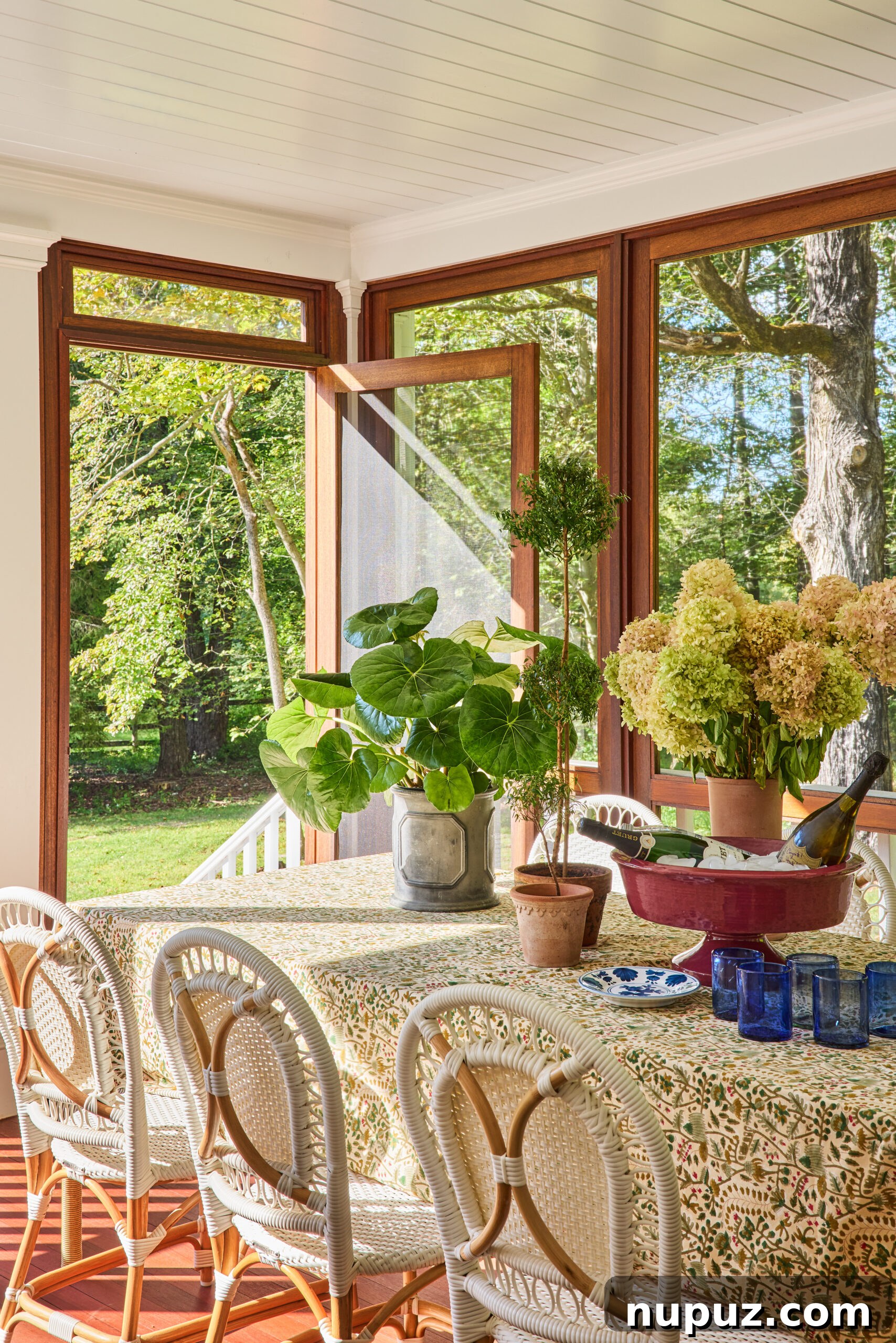Hunter creates perfect spaces in this timeless Bedford home and has us teeming with inspiration. Covered porch with a charming green and white tablecloth