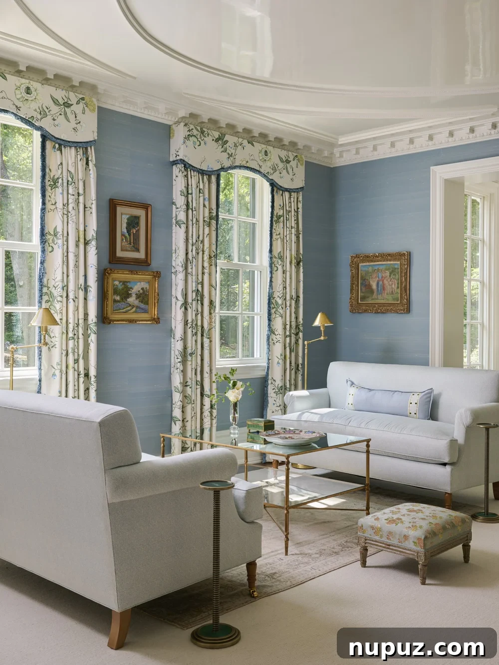 Living room with blue grasscloth and a pair of white sofas