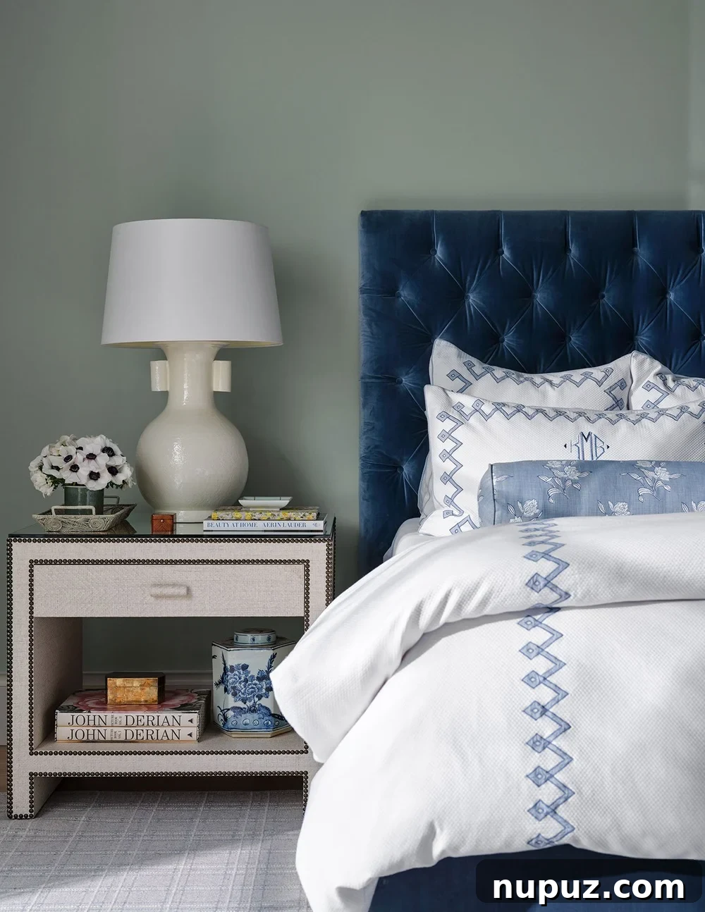 Blue and white bedroom with blue velvet tufted headboard