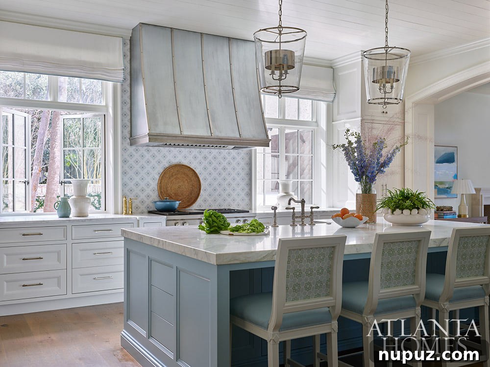 Blue and white kitchen with stainless range hood