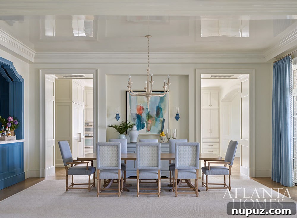 Dining room with lacquered ceiling in blue and white and abstract art
