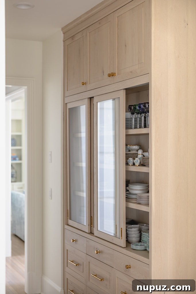 Cabinetry with sliding glass doors and curated styling