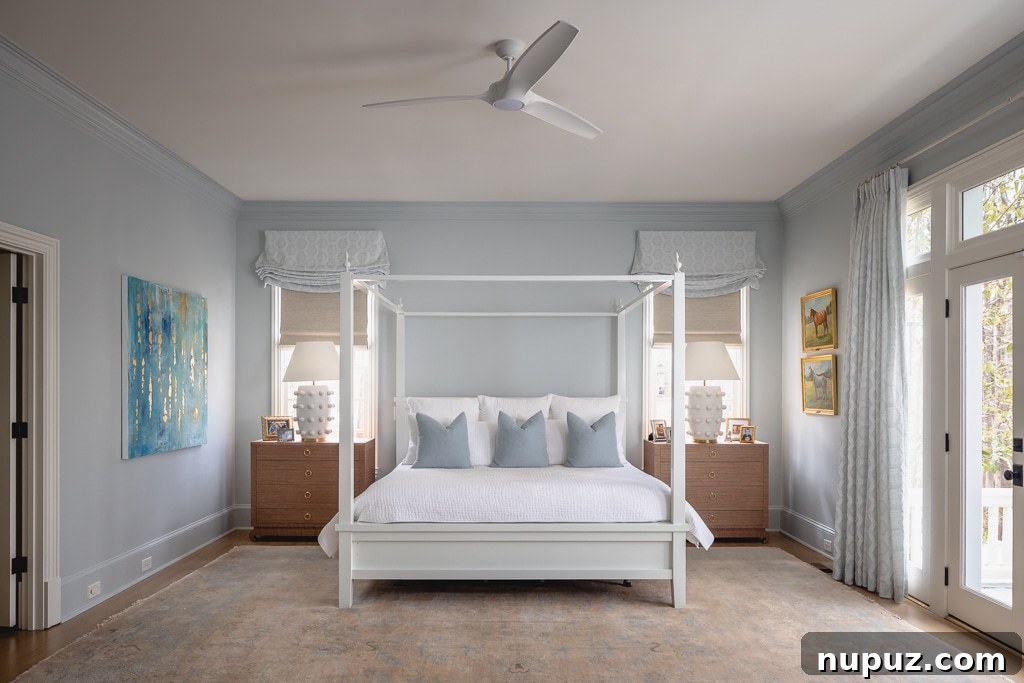 Primary bedroom with blue-and-white canopy bed and layered textiles